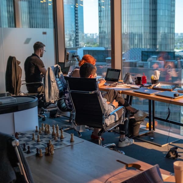 group of people working together at a large table.